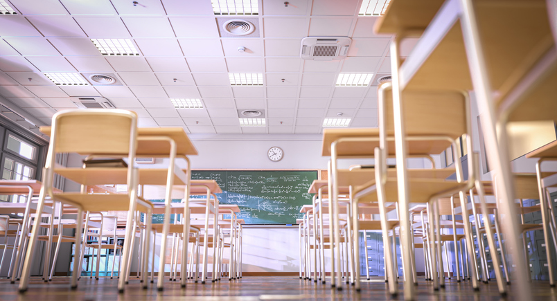 Empty classroom with desks and blackboard is waiting for students